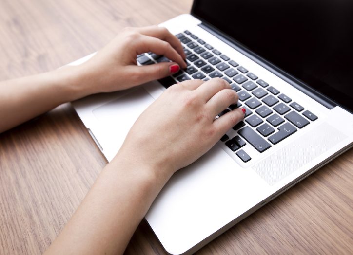lady writing content for her business website on a laptop
