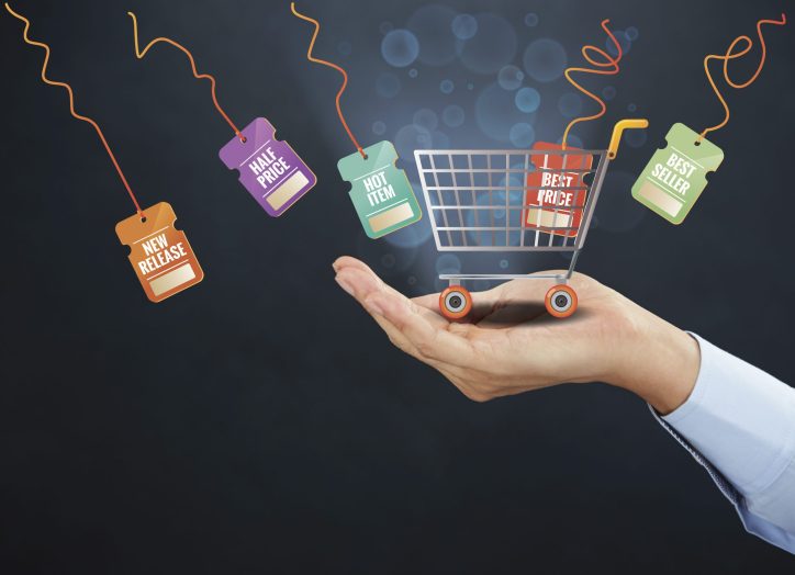 hand holding a little shopping cart representing ecommerce